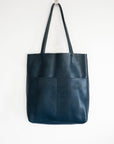 Full grain leather unlined tote bag. It features two interior pockets