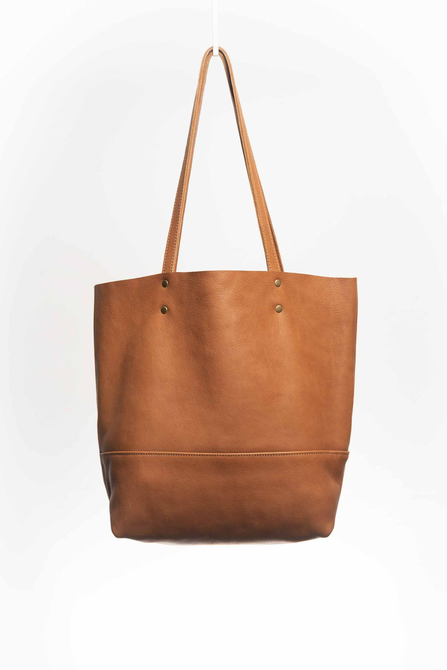 Full grain leather unlined tote bag. It features two interior pockets