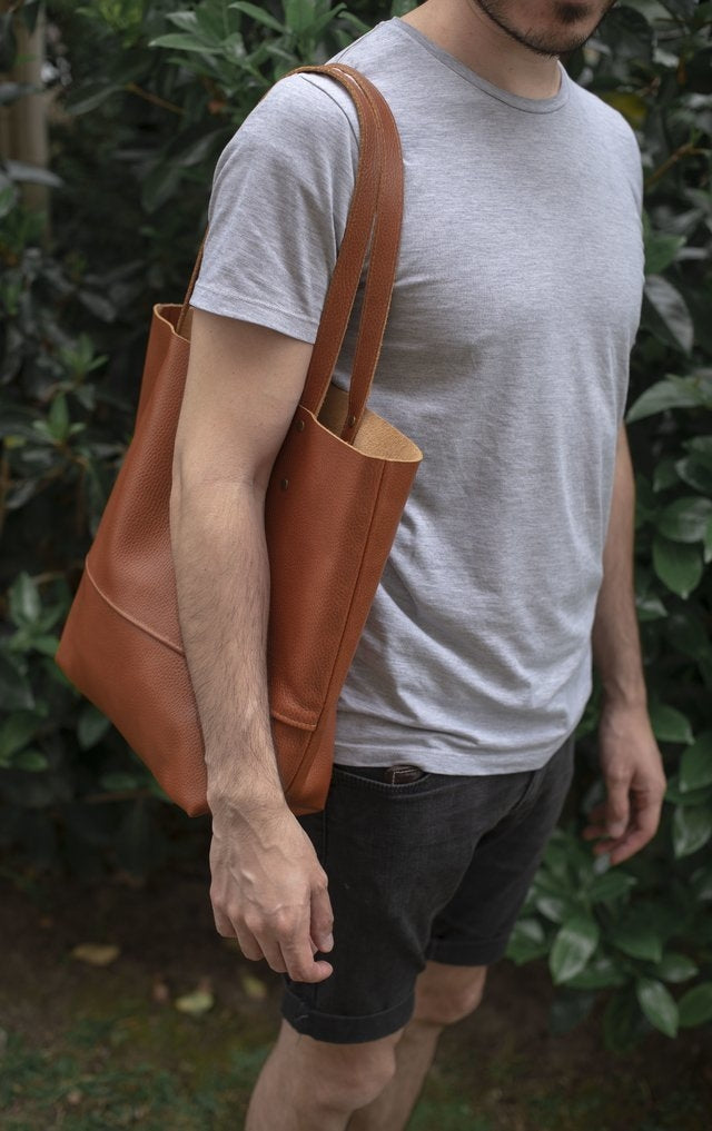 Full grain leather unlined tote bag. It features two interior pockets